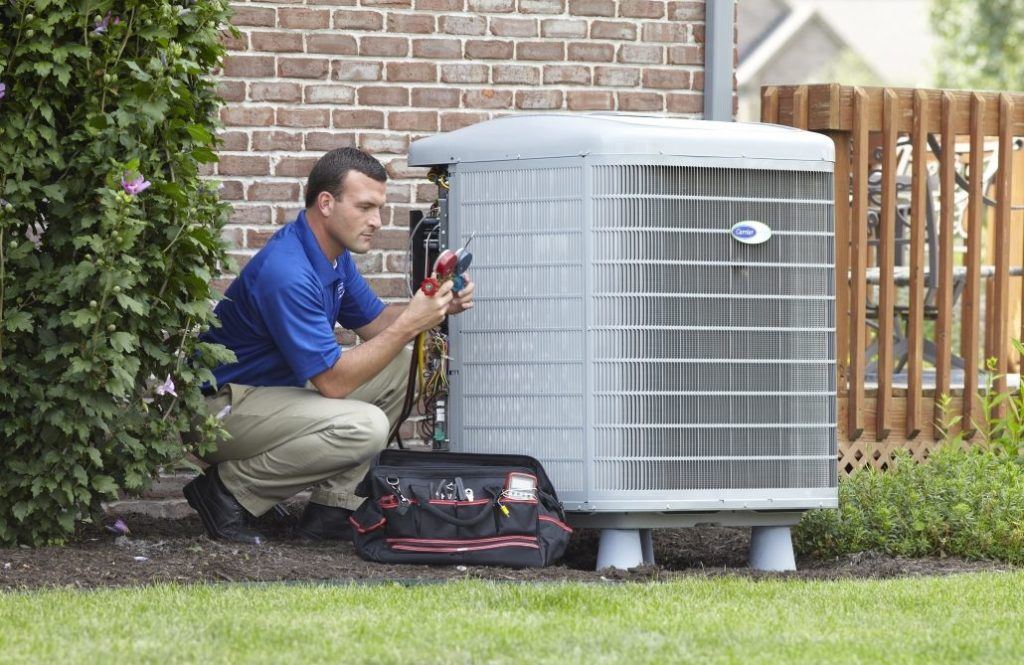 HVAC technician servicing outdoor AC unit